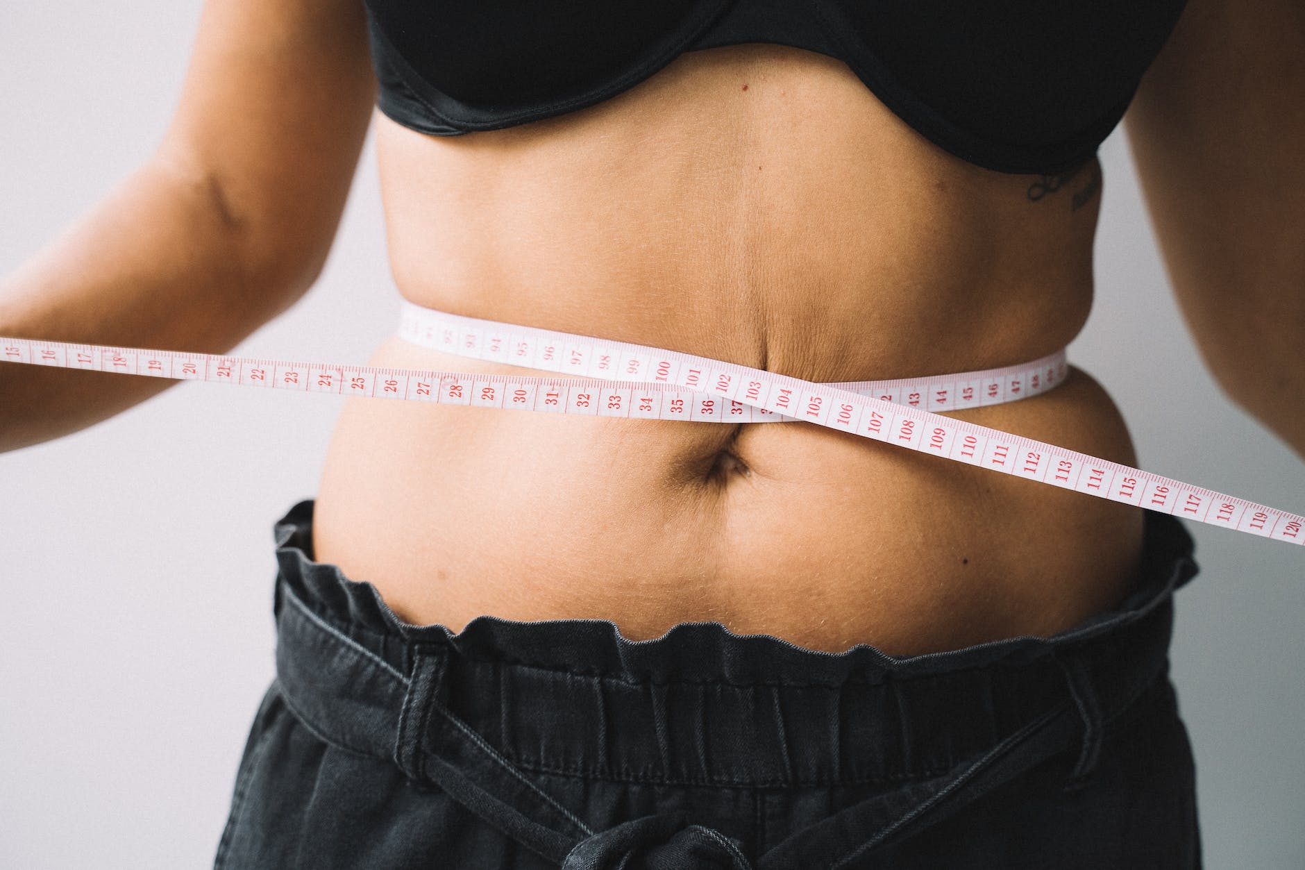 photo of a tape measure on a person s waist