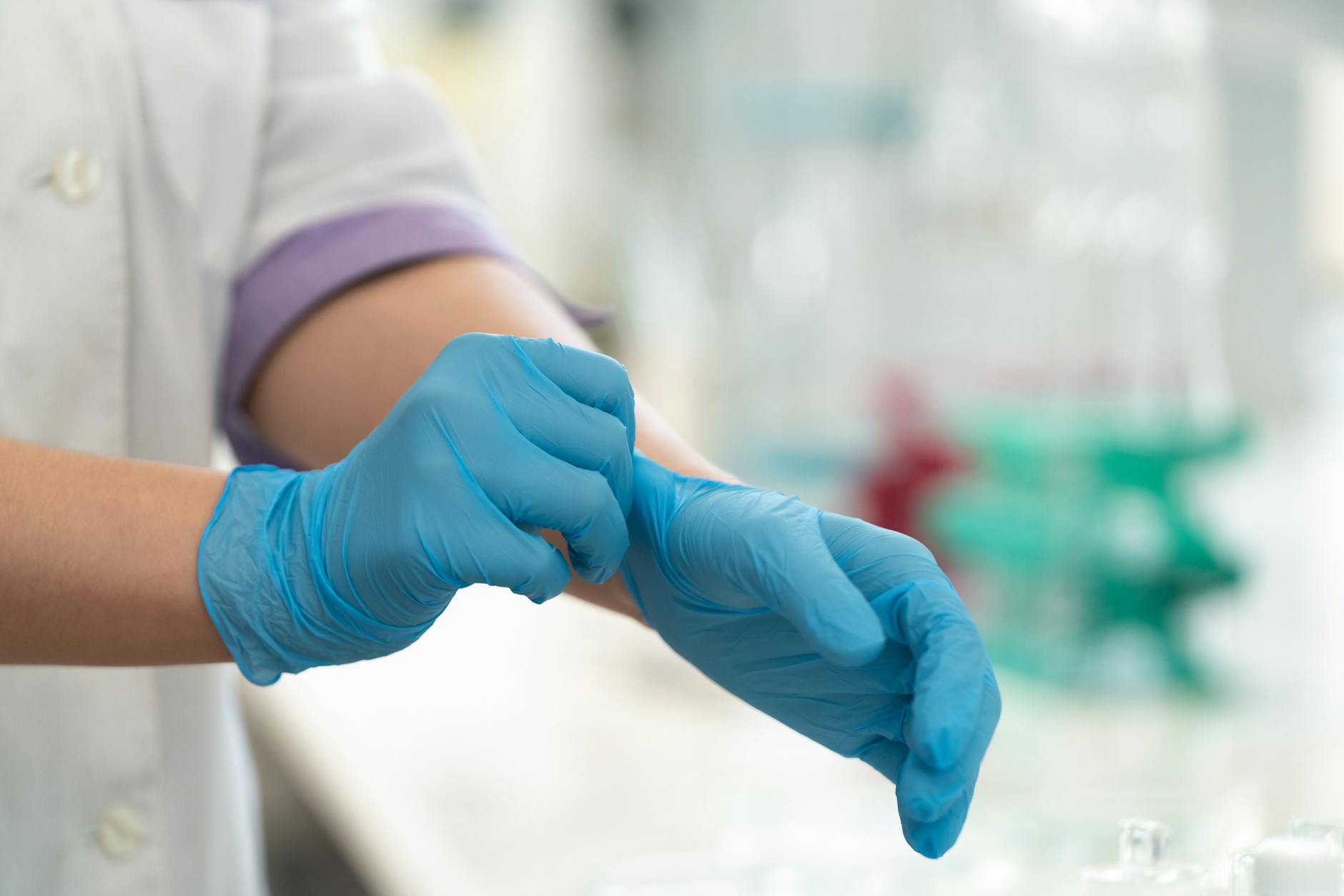 a person wearing blue medical gloves